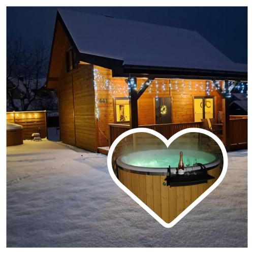 a heart shaped hot tub in the front of a house at Domek w Zabrzeży in Łącko