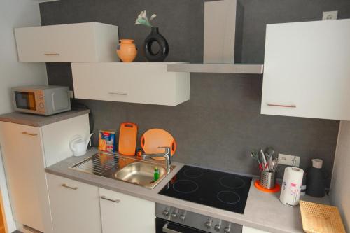 a small kitchen with a sink and a stove at Gabis Ferienwohnung Zwickau in Zwickau