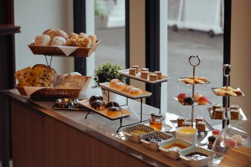a buffet with many different types of pastries and bread at Hotel Holm Bangkok in Bangkok