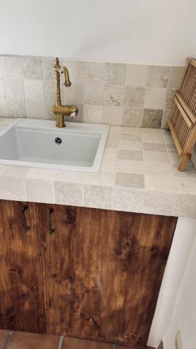 a bathroom with a sink and a wooden floor at MOZa LUZe - Off Grid Casa Rural in El Pilar y Provincias