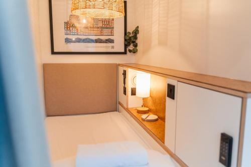 a small room with a bed and a lamp at CODE - The Loft, Edinburgh in Edinburgh