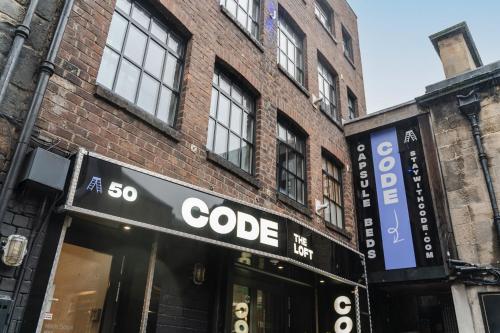 a store with a sign on the side of a brick building at CODE - The Loft, Edinburgh in Edinburgh