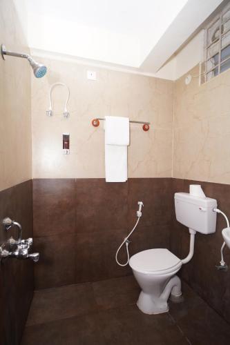 a bathroom with a toilet and a shower at Hotel Stay Bliss Marathahalli in Bangalore