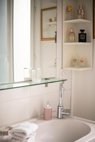 a bathroom with a sink and a mirror at Villa MONIKA in Dieppe