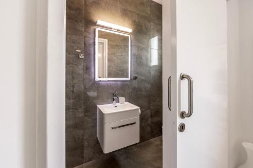 a bathroom with a sink and a mirror at Villa Mesogeios 39 in Paralimni