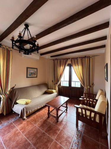 a living room with a couch and a table at Apartamentos Turísticos La Posada in Oropesa