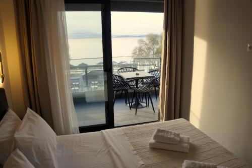 a hotel room with a bed and a view of a balcony at SABBAL apartments in Salamina