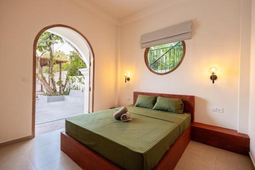 a bedroom with a bed with a stuffed animal on it at Lucky U Hostel in Ahangama