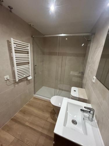 a bathroom with a shower and a sink and a toilet at El Far de Palamós - Costa Brava in Palamós