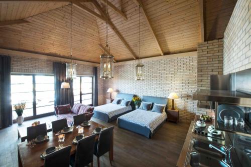 a living room with a couch and a table at Villa Victoria in Rydzewo