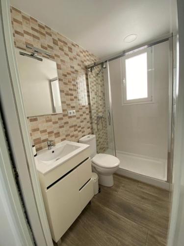 a bathroom with a toilet and a sink and a shower at La Terraza de María P in Torre del Mar