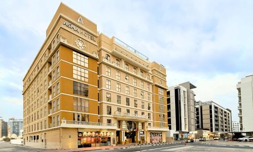 a large building on the corner of a street at Asma Hotel Al Barsha in Dubai