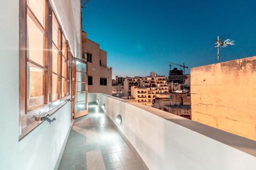 a balcony with a view of a city at 120 Lapsi Apartments in St. Julianʼs