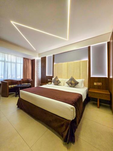 a bedroom with a large bed in a room at Hotel Sapphire in Mombasa