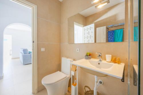 a bathroom with a toilet and a sink at Villa Kuki - PlusHolidays in Ifach
