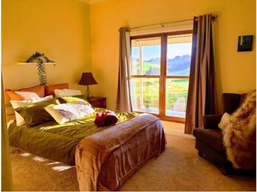 a bedroom with a large bed and a window at JillyPark Farmstay Experience Discover Authentic Farm Life Complimentary Breakfast Included in Buln Buln