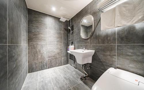 a bathroom with a toilet and a sink at 12th Street Stay in Cheongju