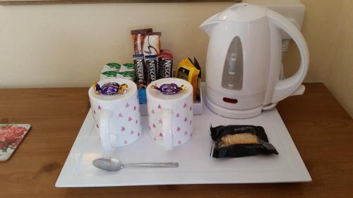 a counter with two coffee cups and a blender at Britannia Guest House in Llandudno