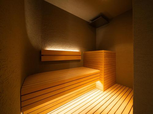 a small sauna with a wooden bed in a room at R Hotel RE Osaka Nagai Park in Osaka