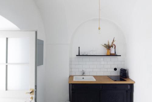a bathroom with a sink and a white wall at Am Znaimertor in Retz