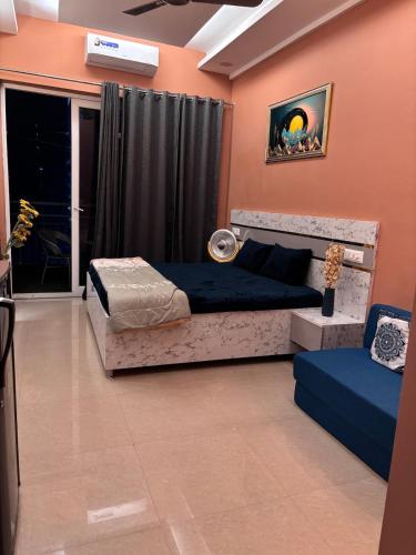 a bedroom with two beds and a window at Good vibes only gaur city center studio apartment in Ghaziabad