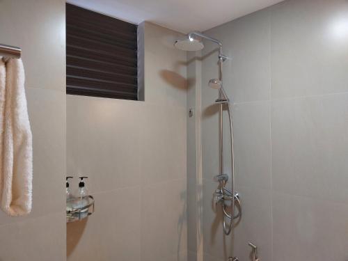 a shower with a glass door in a bathroom at Comfy Cool Breeze by eMzaz in Dhiffushi