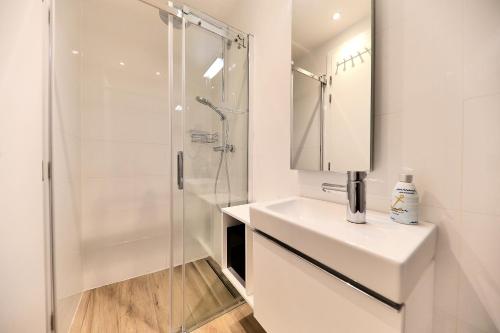 a white bathroom with a shower and a sink at VILLA PAG - SVETA MARIJA in Pag