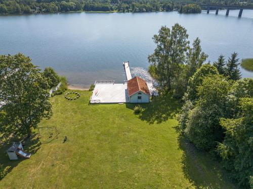 an aerial view of a house on the shore of a lake at Villa Kolartorp in Ekolsund