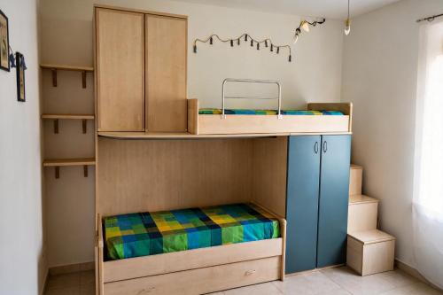 a room with a bunk bed and a cabinet at Casa Effe in Cecina