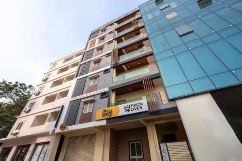 a tall building with a sign in front of it at Itsy Hotels Saffron Groves in Hyderabad