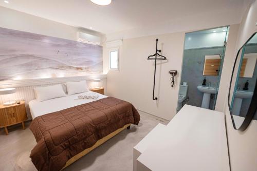 a hotel room with a bed and a bathroom at LUX Hotel 5 mins walk from port of Piraeus and metro station in Piraeus