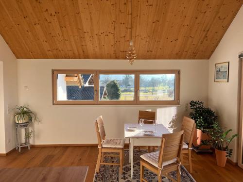 a dining room with a table and chairs and a window at Apartment Vinomna in Rankweil