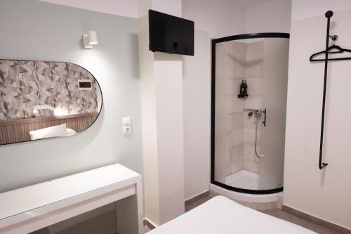 a bathroom with a shower and a sink and a mirror at LUX Hotel 5 mins walk from port of Piraeus and metro station in Piraeus