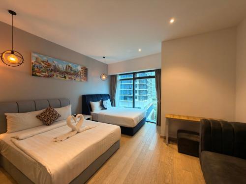 a hotel room with two beds and a couch at IKON SUITE's E A T O N KLCC in Kuala Lumpur
