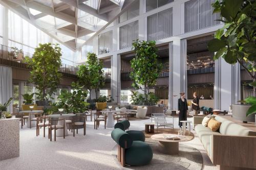 a rendering of a lobby with tables and chairs at Estrel Tower in Berlin