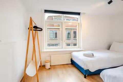 a bedroom with a bed and a window at Large Family House Alkmaar in Alkmaar