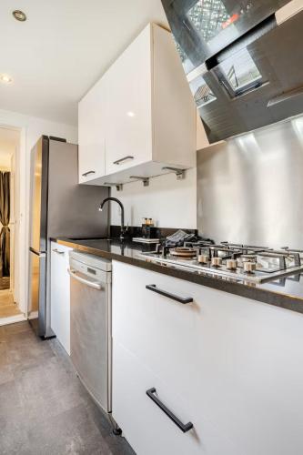 a kitchen with stainless steel appliances and white cabinets at Large Family House Alkmaar in Alkmaar