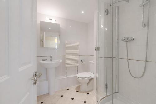 a bathroom with a toilet and a sink and a shower at Roomspace Serviced Apartments - The Courtyard in London
