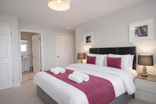 a bedroom with a large bed with two towels on it at Roomspace Serviced Apartments - The Courtyard in London