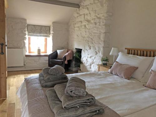 a bedroom with a large bed with towels on it at 3 Bed in Blaenau Ffestiniog oc-wah538 in Trawsfynydd
