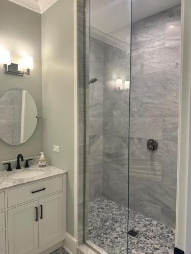 a bathroom with a shower with a glass door at The Lyons' Den in Chicago