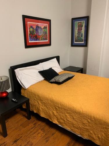 a bedroom with a bed with a laptop on it at Creole Nest 2 in New Orleans