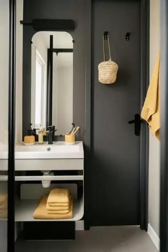 a bathroom with a white sink and a mirror at ZEcamping 3 étoiles vue exceptionnelle et soirées animées in Gex