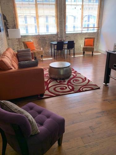 a living room with a couch and a rug at Creole Nest 2 in New Orleans