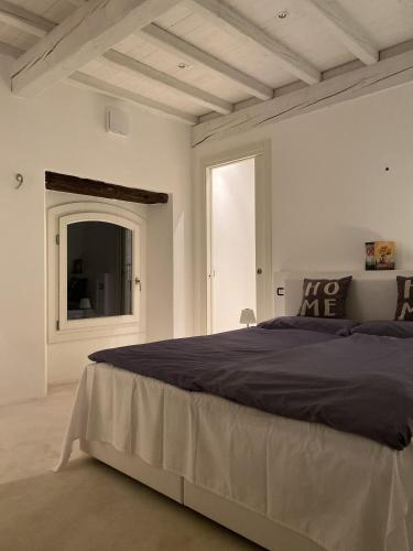 a bedroom with a large bed and a window at Lago Lounge & Pool in Stresa