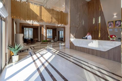 a lobby of a hotel with a person standing at a counter at بيست ليفل للشقق المخدومة in Al Khobar