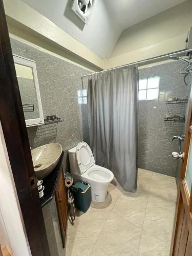 a bathroom with a toilet and a sink and a shower at Samakki Residence - Modern Rooms, Quiet Area, Near the Beach in Rawai Beach