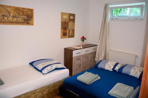 a bedroom with two twin beds and a window at AB Holiday Home in Siófok