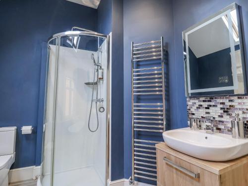 a bathroom with a sink and a shower at Holly Lodge in Aldeburgh