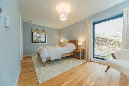 a bedroom with a bed and a large window at The Star House in Glendale